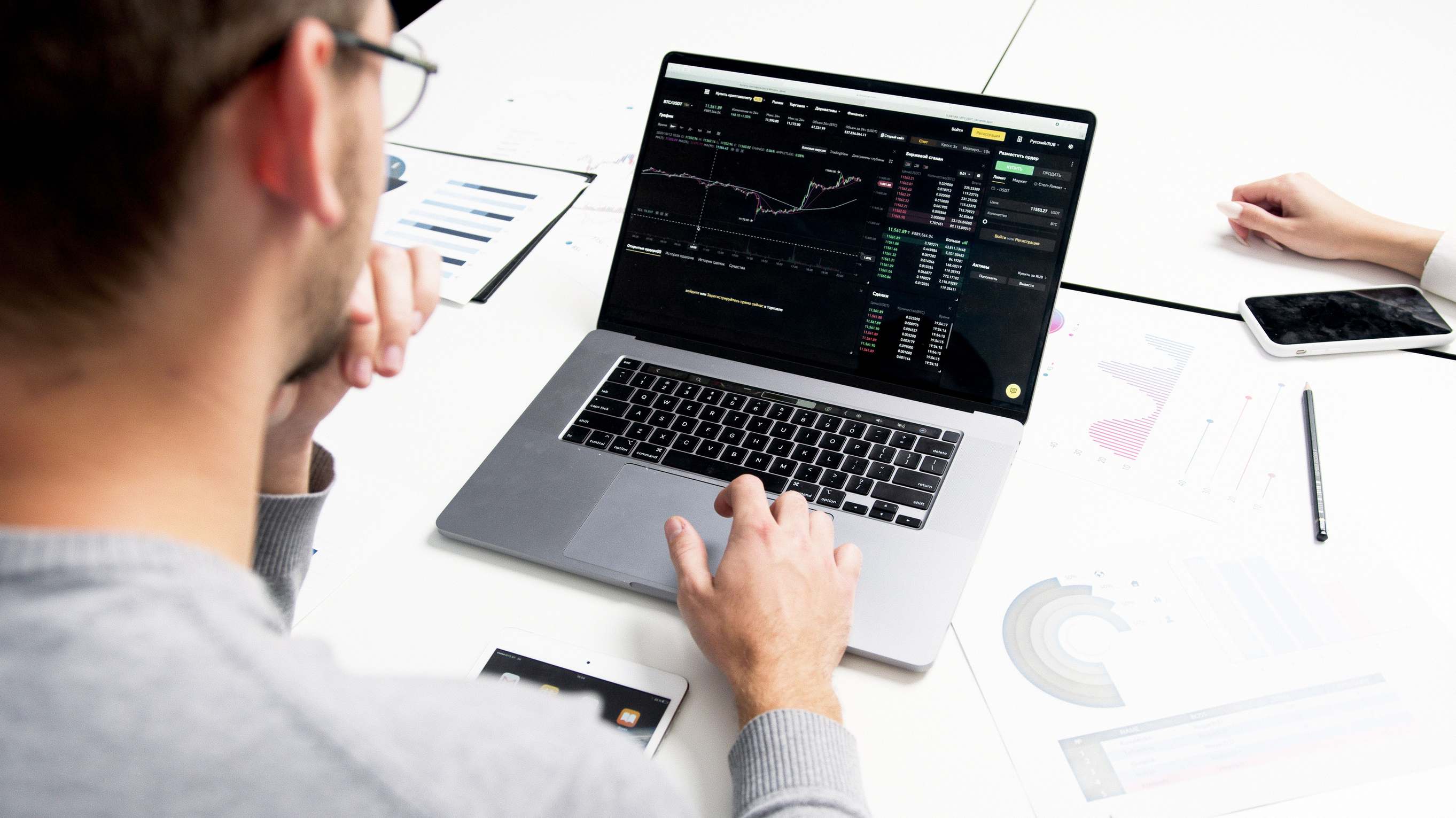 Workspace with a laptop showing a financial spreadsheet — Business professional analyzing stock market data on a laptop for investment insights.